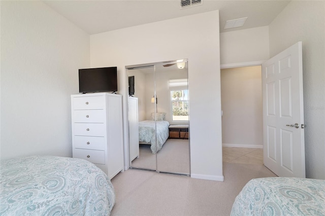 bedroom featuring light colored carpet and a closet