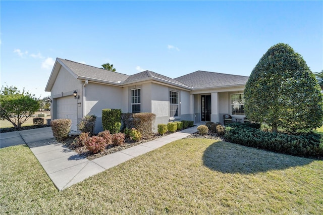 view of front of property featuring a garage and a front yard