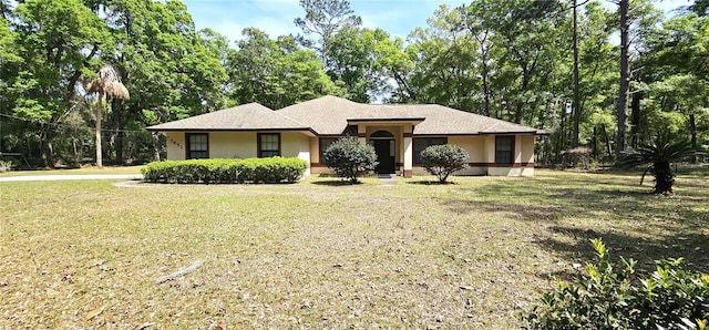 7651 SE 36th Ave, Ocala, FL 34480 - single story home with a front lawn and stucco siding