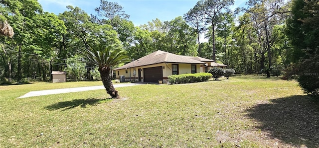 7651 SE 36th Ave, Ocala, FL 34480 - exterior space featuring driveway, a yard, and an attached garage