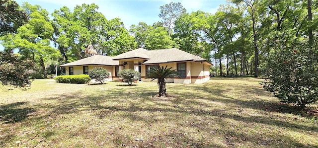 7651 SE 36th Ave, Ocala, FL 34480 - view of front facade featuring stucco siding and a front yard