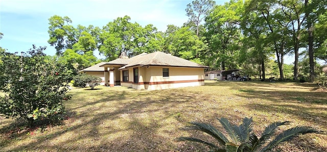7651 SE 36th Ave, Ocala, FL 34480 - view of side of home with a lawn and stucco siding