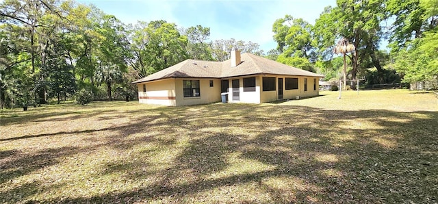 7651 SE 36th Ave, Ocala, FL 34480 - back of house with a sunroom and a chimney