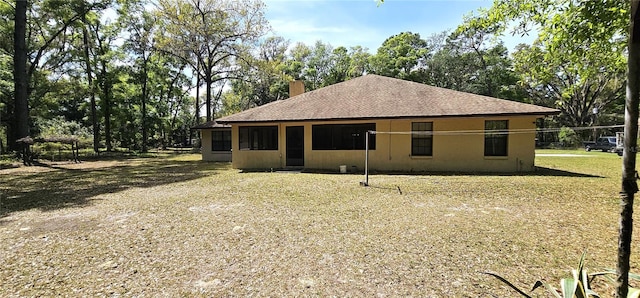 7651 SE 36th Ave, Ocala, FL 34480 - exterior space with a chimney, a shingled roof, and stucco siding
