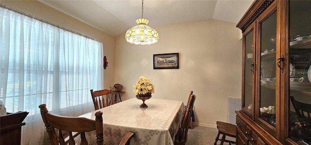 7651 SE 36th Ave, Ocala, FL 34480 - carpeted dining area featuring baseboards, vaulted ceiling, and visible vents