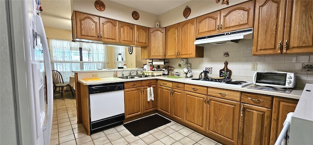 7651 SE 36th Ave, Ocala, FL 34480 - kitchen featuring under cabinet range hood, a sink, brown cabinetry, and white appliances