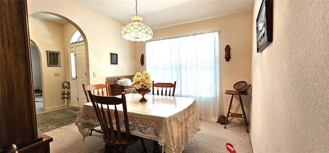 7651 SE 36th Ave, Ocala, FL 34480 - dining area with light carpet, baseboards, and arched walkways