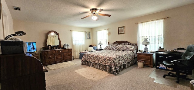 7651 SE 36th Ave, Ocala, FL 34480 - bedroom featuring light carpet, a textured ceiling, ceiling fan, and visible vents