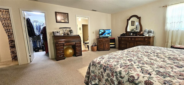 7651 SE 36th Ave, Ocala, FL 34480 - carpeted bedroom with a walk in closet, a textured ceiling, and visible vents
