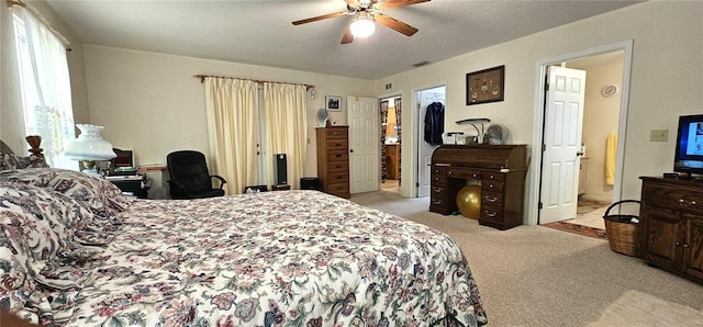 7651 SE 36th Ave, Ocala, FL 34480 - bedroom with a ceiling fan, a textured ceiling, ensuite bath, light colored carpet, and visible vents