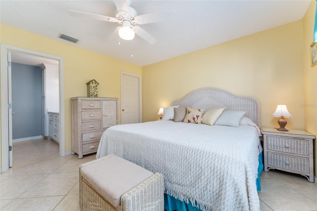 bedroom with light tile patterned floors, a textured ceiling, and ceiling fan