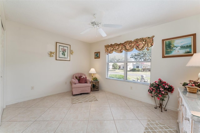 living area featuring light tile patterned flooring and ceiling fan