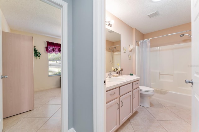 full bathroom featuring vanity, tile patterned flooring, and a textured ceiling