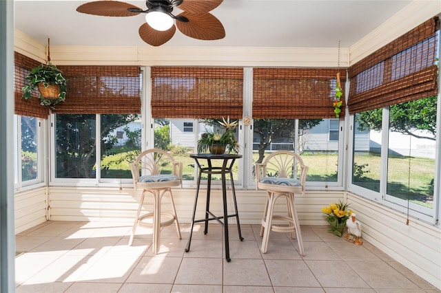 unfurnished sunroom with ceiling fan