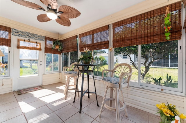 sunroom / solarium featuring ceiling fan