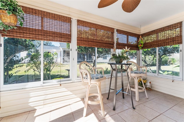 sunroom featuring ceiling fan