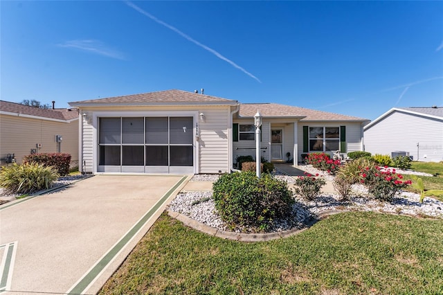 ranch-style house featuring a garage and a front yard