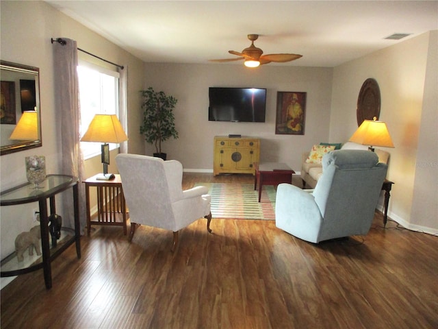 living room with dark hardwood / wood-style floors and ceiling fan