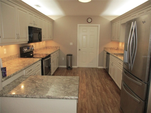 kitchen featuring baseboards, appliances with stainless steel finishes, light stone counters, and dark wood-type flooring