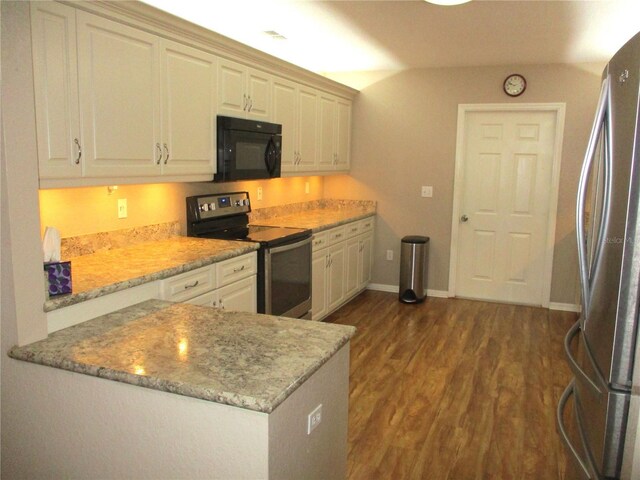 kitchen featuring baseboards, dark wood finished floors, light stone counters, a peninsula, and stainless steel appliances