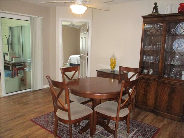 dining room featuring a ceiling fan and wood finished floors