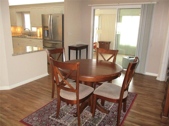 dining area with dark wood-style floors and baseboards