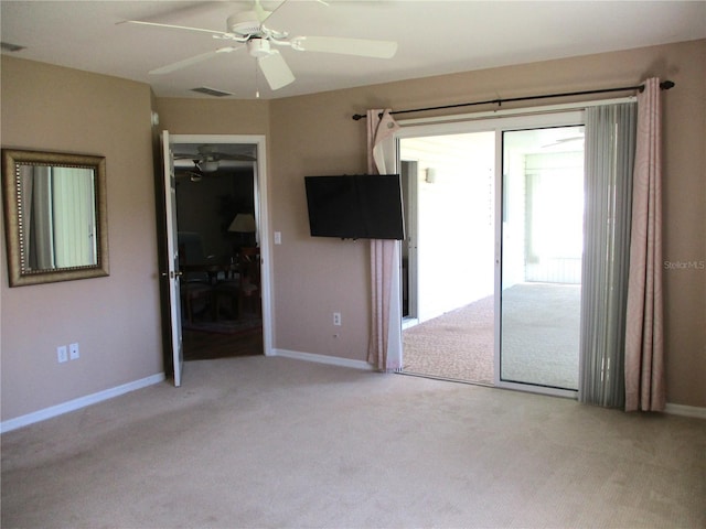 unfurnished room with baseboards, visible vents, a ceiling fan, and light colored carpet