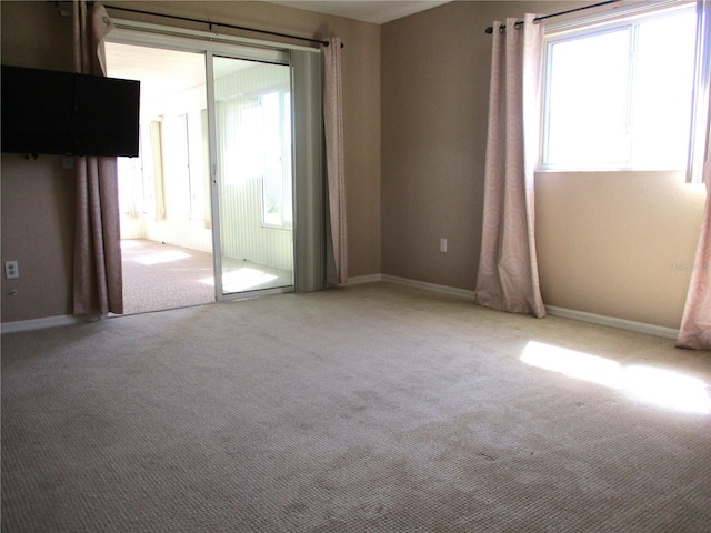 spare room with carpet and baseboards