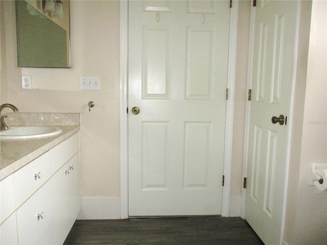 bathroom with wood finished floors and vanity