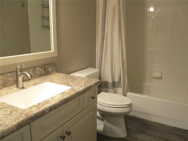 full bathroom featuring wood finished floors, vanity, toilet, and shower / bath combo with shower curtain