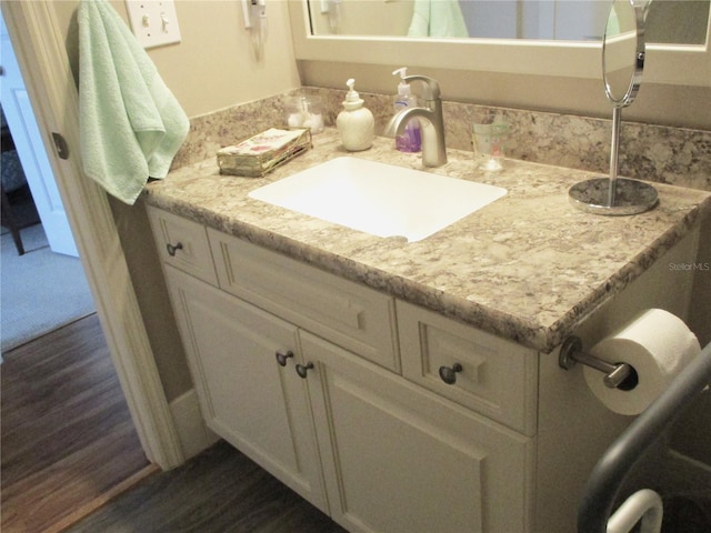 bathroom with wood finished floors and vanity