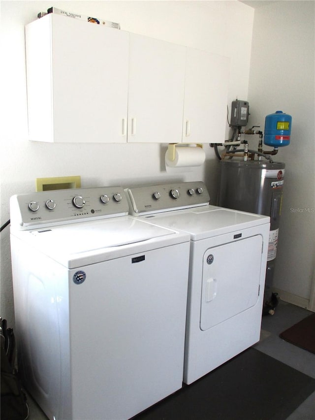 laundry room with cabinet space, washing machine and dryer, and electric water heater