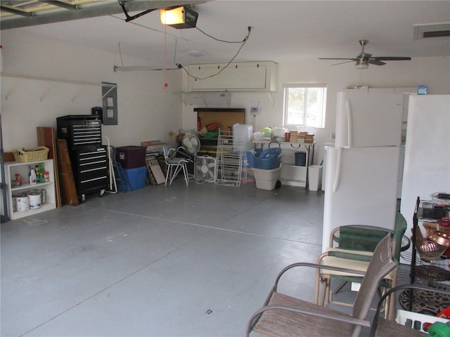 garage with electric panel, visible vents, and a garage door opener