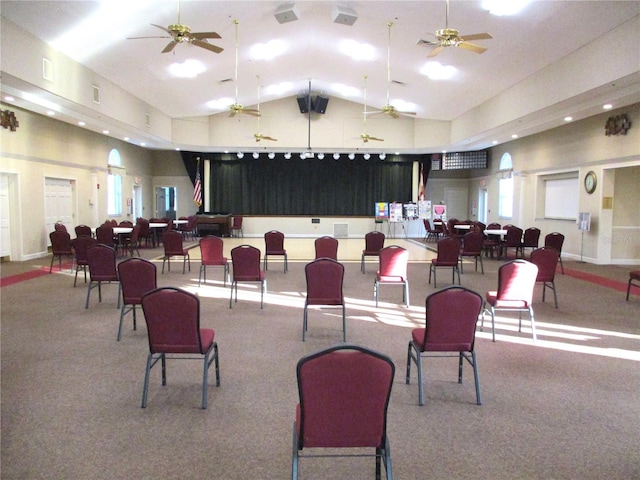 interior space featuring high vaulted ceiling, carpet, and visible vents