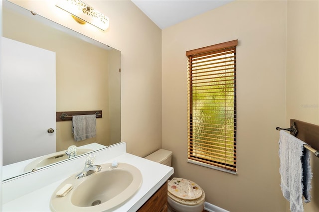 bathroom featuring vanity and toilet