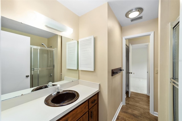 bathroom featuring vanity, hardwood / wood-style floors, and an enclosed shower