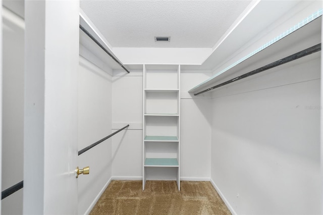 spacious closet with dark carpet