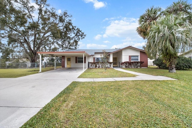 ranch-style home with a front lawn and a carport