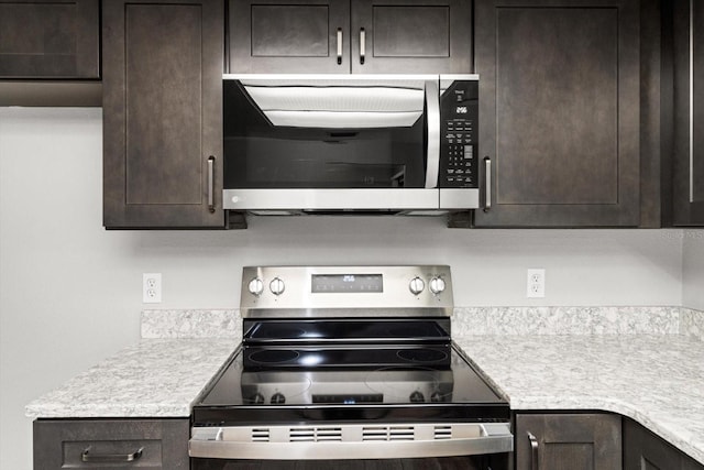 kitchen featuring dark brown cabinetry and stainless steel appliances