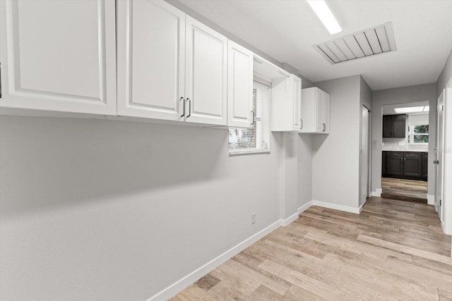 laundry room with light hardwood / wood-style floors