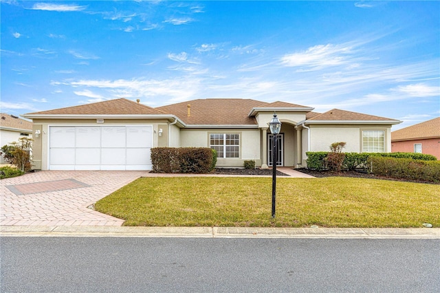 ranch-style home with a garage and a front lawn