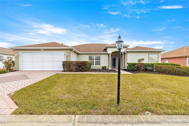 ranch-style house featuring a garage and a front yard