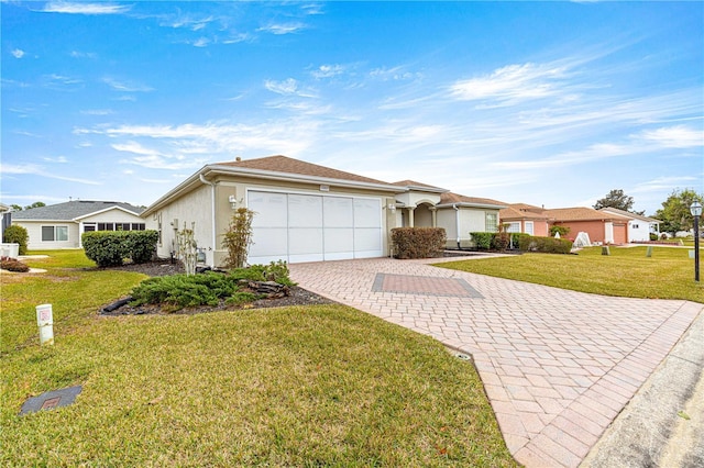 ranch-style house featuring a garage and a front lawn