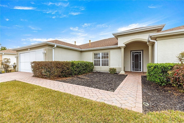 single story home featuring a garage and a front yard