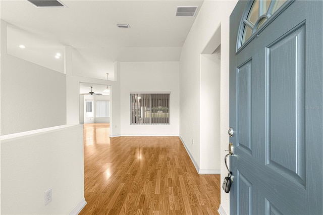 corridor with hardwood / wood-style floors