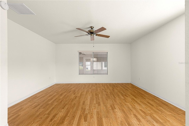 spare room featuring ceiling fan and light hardwood / wood-style flooring