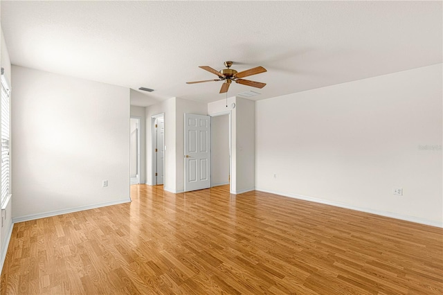 spare room featuring ceiling fan and light wood-type flooring