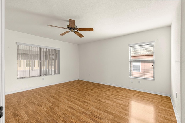 unfurnished room with ceiling fan and light wood-type flooring