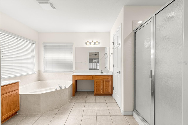 bathroom featuring vanity, tile patterned floors, and shower with separate bathtub