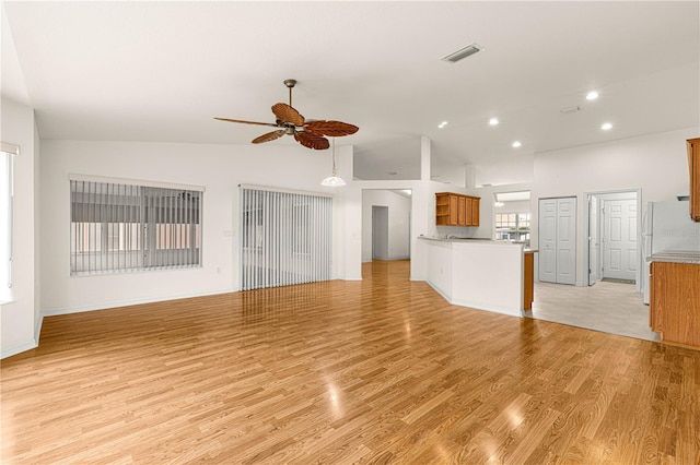 unfurnished living room featuring high vaulted ceiling, ceiling fan, and light wood-type flooring